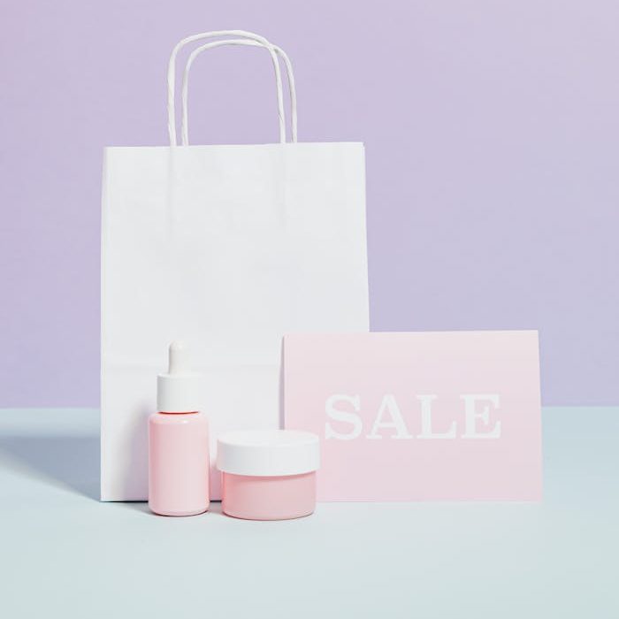 Elegant beauty product display with sale sign and shopping bag in minimalist style.